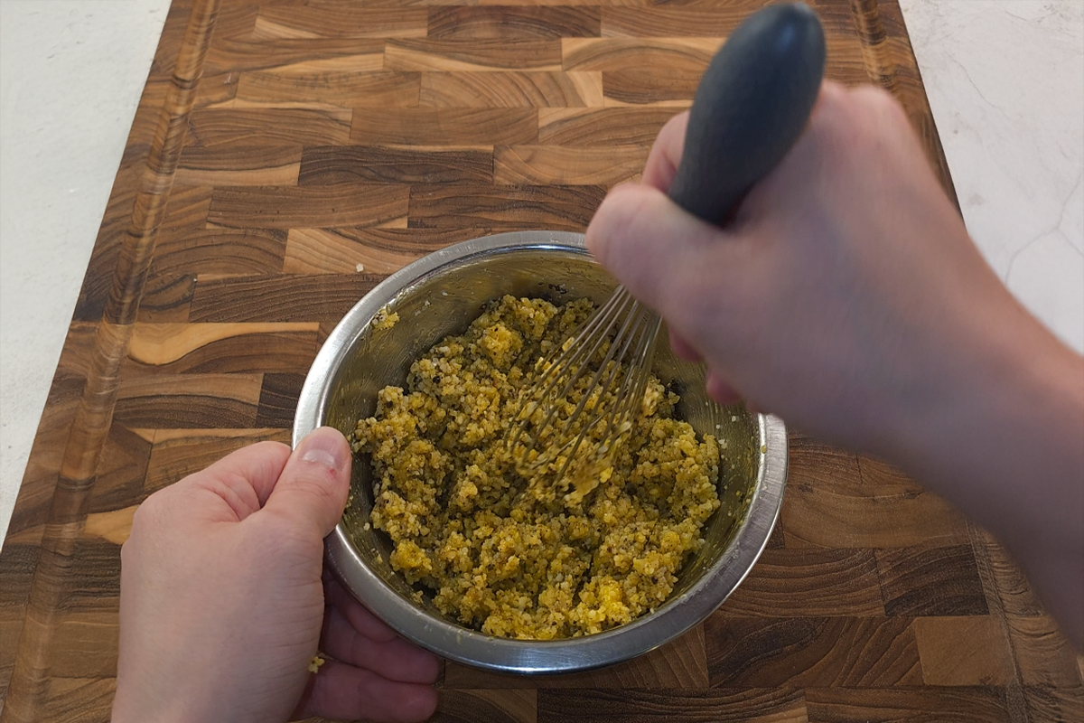 Whisking eggs, Pecorino Romano, Parmigiano Reggiano, salt, and black pepper into a rich carbonara mixture for a silky pasta sauce.